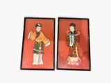 two framed pictures of a woman and a man on a red background