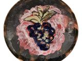 une assiette sur laquelle est représentée une grappe de raisin