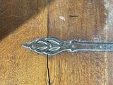 a close up of a wooden table with a pair of scissors on it