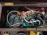 a wooden box filled with assorted beads and bracelets