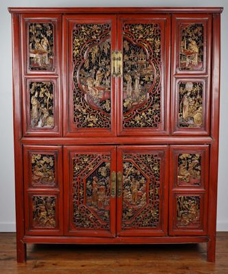 an antique chinese cabinet with carved panels on the doors and drawers