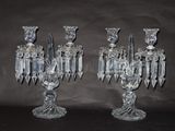 pair of clear crystal candlesticks on a black background
