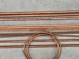 a bunch of copper pipes sitting on top of a table