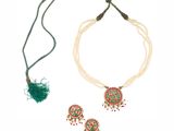 a close up of a necklace and earrings on a white background