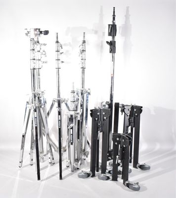 a lot of different types of tripod stands on a white background