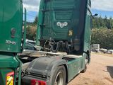 a green truck that is parked on the side of the road