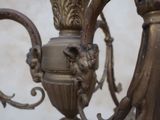 a close up of a chandelier with a bird on it