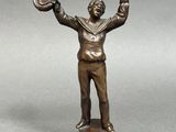 bronze figurine of a man holding a hat and a glove