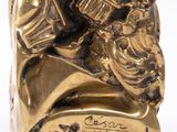 gold plated figurine of a man and woman on a horse