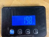 a digital clock on a table with a charger