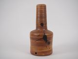 a brown vase with a bird on it on a white surface