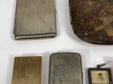 four different types of cigarette cases and a case with a picture on it