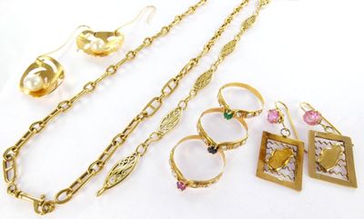 several pieces of jewelry sitting on top of a table next to each other