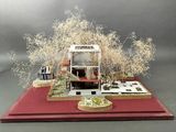 a miniature model of a house on a red table