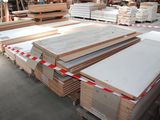 many stacks of wood in a warehouse with pallets on the floor