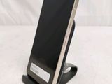 a cell phone that is on a stand on a table