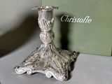 a silver candle holder sitting on a table next to a box
