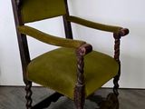 a green chair with a clock on the back of it