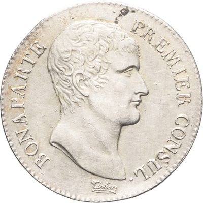 Gros plan sur une pièce de monnaie portant le visage d'un homme