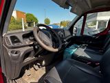 a red truck with black seats and a steering wheel