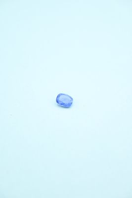 a blue stone in the middle of a snow covered field