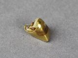 a small gold object that is on a table