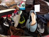 many pairs of shoes in a basket on the floor