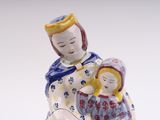 a figurine of a woman holding a child