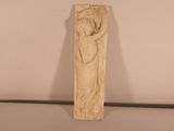statue of a woman holding a child in her arms on a table