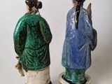 pair of ceramic figurines of a man and a woman in blue and green