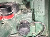 a close up of a green machine with wires attached to it