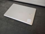 a laptop sitting on the floor in front of a door