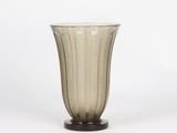 the vase is made of glass and has a wooden base