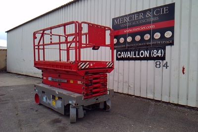 a picture of a red scissor parked in front of a building