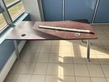 a wooden table with a pen and a pencil on it