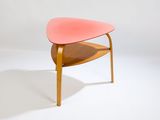 a small pink chair with a wooden frame on it