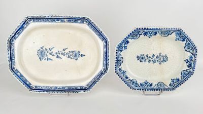 two blue and white plates with designs on them on a white surface
