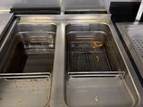 two sinks in the kitchen that have food in them