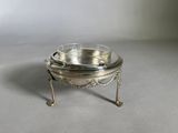 a silver plate that is sitting on a stand