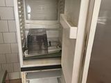 an open refrigerator in a small kitchen with no door