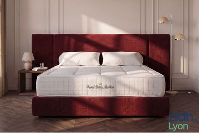 a picture of a bed with a red headboard in a room