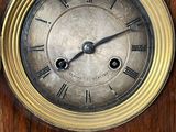a clock that is on the side of a wooden wall