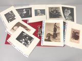 a lot of old black and white photos on a table