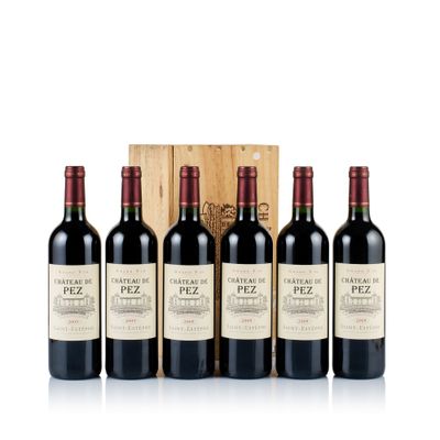 four bottles of red wine in a wooden box