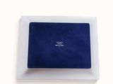 a picture of a white plate with a blue square on it