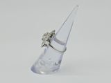 a clear glass cone with a diamond ring on top of it