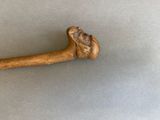 a wooden stick with a head on it on a table