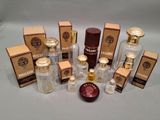several bottles of perfume sitting on top of a table next to boxes of perfume