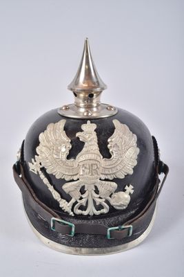 an old helmet with a bird on it sitting on top of a table