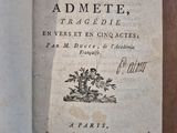 an old book that is open on a wooden table